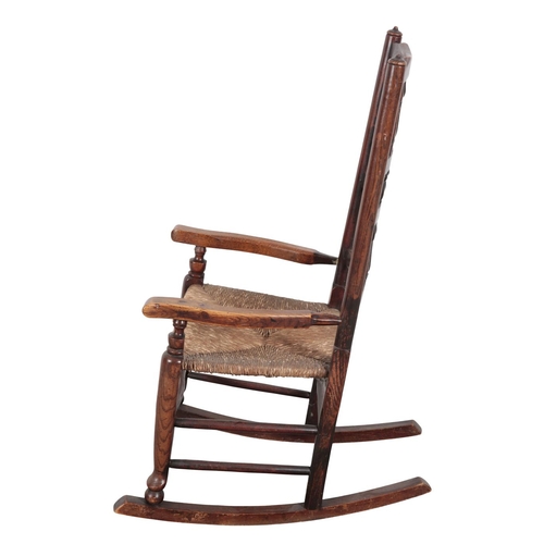 822 - AN EARLY 19TH CENTURY LANCASHIRE SPINDLE-BACK ROCKING CHAIR

various woods, with rush seat and pad f... 