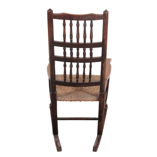 822 - AN EARLY 19TH CENTURY LANCASHIRE SPINDLE-BACK ROCKING CHAIR

various woods, with rush seat and pad f... 