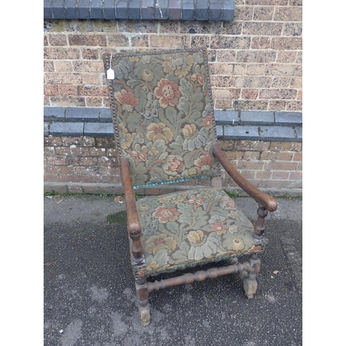 828 - A FRENCH 18th CENTURY WALNUT ARMCHAIR

with turned les and stretchers, and rectangular back 58cm wid... 