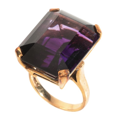 16 - AN AMETHYST COCKTAIL RING

in 9ct gold, set with a step cut amethyst of c.26.99 carats, full British... 