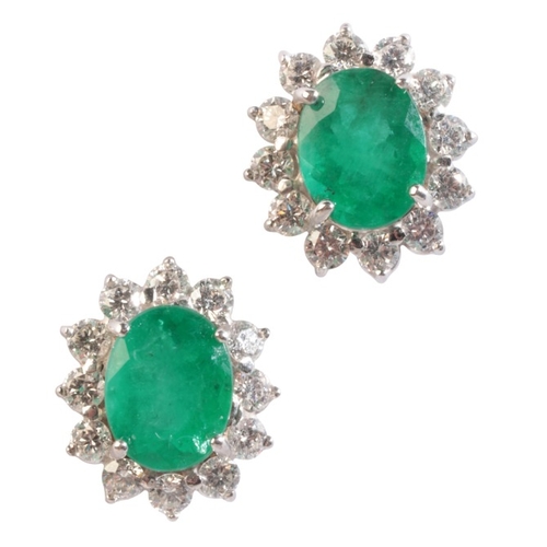 162 - A PAIR OF EMERALD AND DIAMOND CLUSTER EARRINGS

in 18ct white gold, each set with an oval cut emeral... 