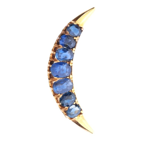 226 - A SAPPHIRE CRESCENT BROOCH

in 14ct gold, set with seven graduating oval cut sapphires, secured with... 