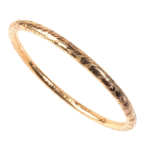 255 - A PRE-WORLD WAR II GOLD BANGLE

in 14ct gold, engraved throughout with floral details, stamped '585'... 