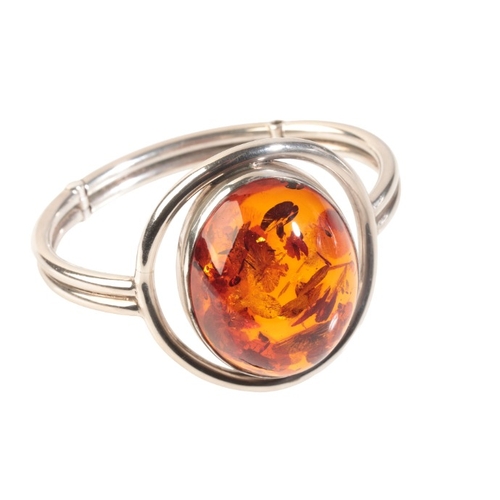 262 - A CONTEMPORARY AMBER BANGLE

in sterling silver, set with an amber cabochon of 39x30x16mm, c.54.59 c... 