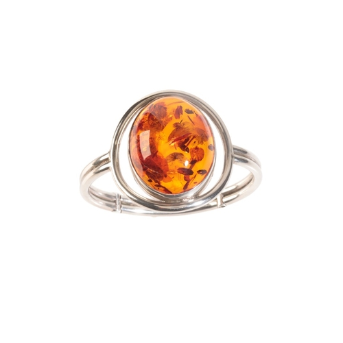 262 - A CONTEMPORARY AMBER BANGLE

in sterling silver, set with an amber cabochon of 39x30x16mm, c.54.59 c... 