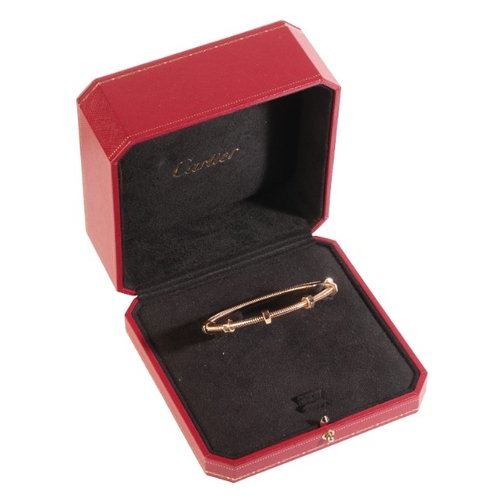 263 - CARTIER: AN 'ÉCROU DE CARTIER' BRACELET

in 18ct gold, in a stylised bolt design with six turning nu... 