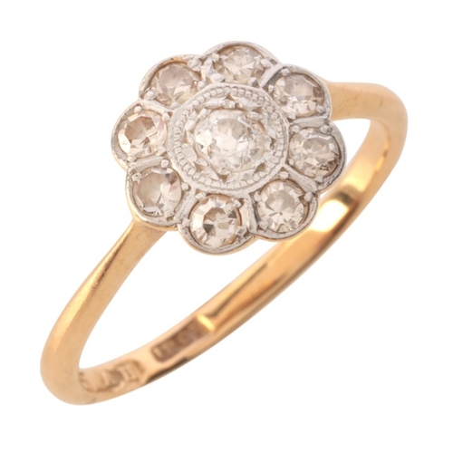 39 - A DIAMOND CLUSTER RING

in 18ct gold and platinum, set with an old mine cut diamond, surrounded by a... 