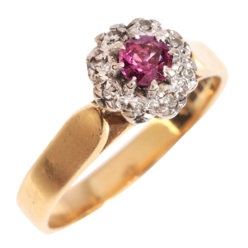 5 - A RUBY AND DIAMOND CLUSTER RING

in 18ct, set with a round cut ruby, surrounded by a cluster of sing... 