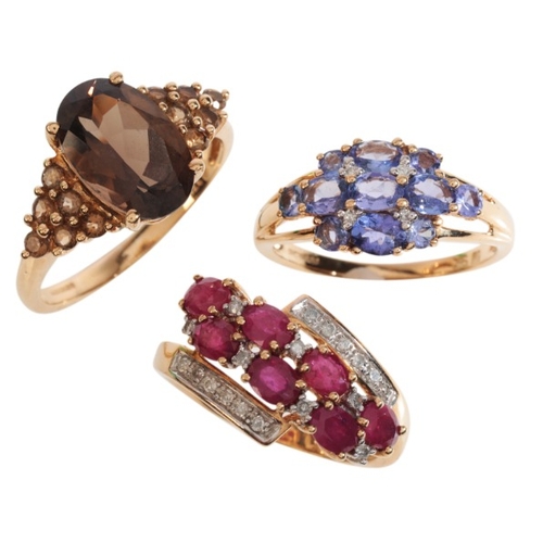 58 - THREE GEM-SET RINGS

in 9ct gold, including a ruby and diamond cross-over ring, set with oval cut ru... 