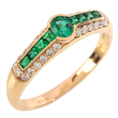 60 - AN EMERALD AND DIAMOND RING

in 18ct gold, set with an oval cut emerald, to shoulders set with calib... 