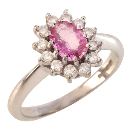 61 - A PINK SAPPHIRE AND DIAMOND CLUSTER RING

in 18ct white gold, set with an oval cut pink sapphire of ... 