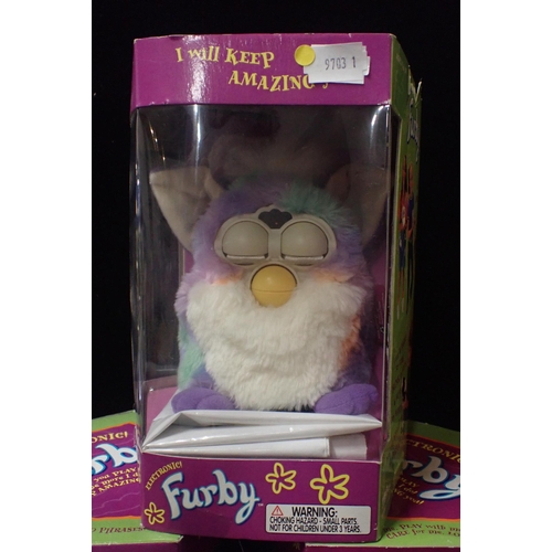 129 - SIX BOXED ORGINAL 1998 FURBIES

including a tagged original Tie Dye Rainbow Furby. Some damage to th... 