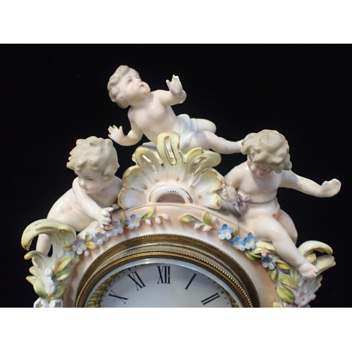 162 - A GERMAN PORCELAIN MANTEL CLOCK CASE

depicting shepherd and shepherdess, 38cm high (with later batt... 