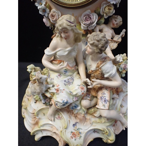 162 - A GERMAN PORCELAIN MANTEL CLOCK CASE

depicting shepherd and shepherdess, 38cm high (with later batt... 