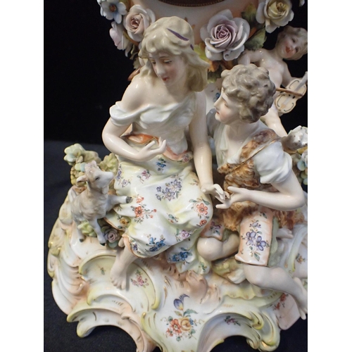 162 - A GERMAN PORCELAIN MANTEL CLOCK CASE

depicting shepherd and shepherdess, 38cm high (with later batt... 