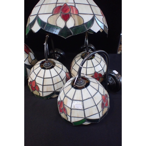 167 - A SET OF TIFFANY STYLE GLASS LIGHTS

Three hanging ceiling lamps, 40cm diam, with three wall lamps, ... 