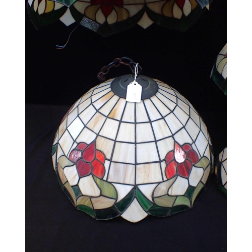 167 - A SET OF TIFFANY STYLE GLASS LIGHTS

Three hanging ceiling lamps, 40cm diam, with three wall lamps, ... 