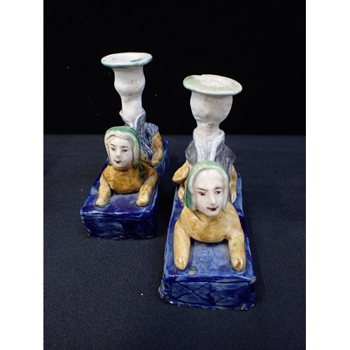 217 - THREE BASIL MATTHEWS STUDIO OWL FIGURES

a pair of pottery sphinx candlesticks, a Crummles enamel bo... 