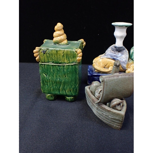 217 - THREE BASIL MATTHEWS STUDIO OWL FIGURES

a pair of pottery sphinx candlesticks, a Crummles enamel bo... 