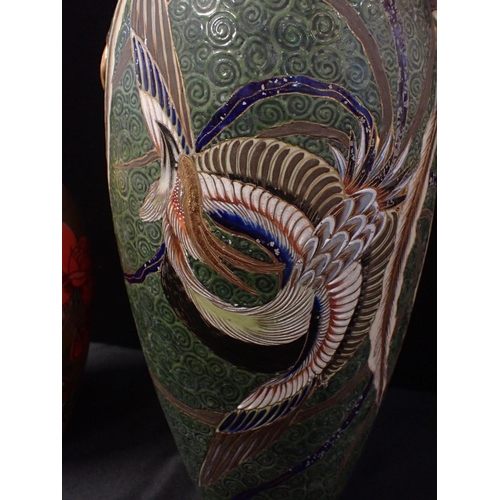 246 - AN EARLY 20TH CENTURY JAPANESE SATSUMA POTTERY VASE

decorated with peacocks on a textured green gro... 