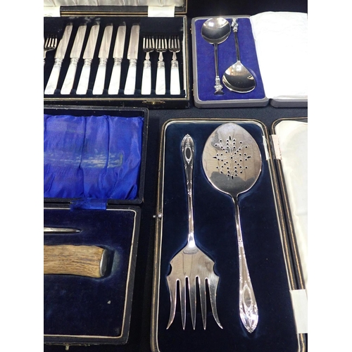 255 - A CASED SET OF CUT GLASS SALTS

with mother of pearl spoons, a set of cased mother of pearl plated f... 