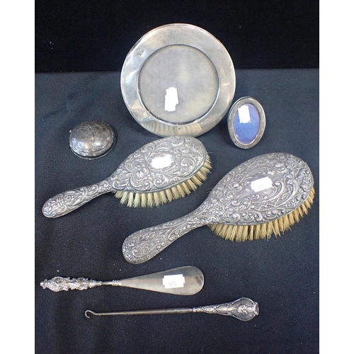 296 - A SILVER BACKED BRUSH SET

with a silver photograph frame and other items