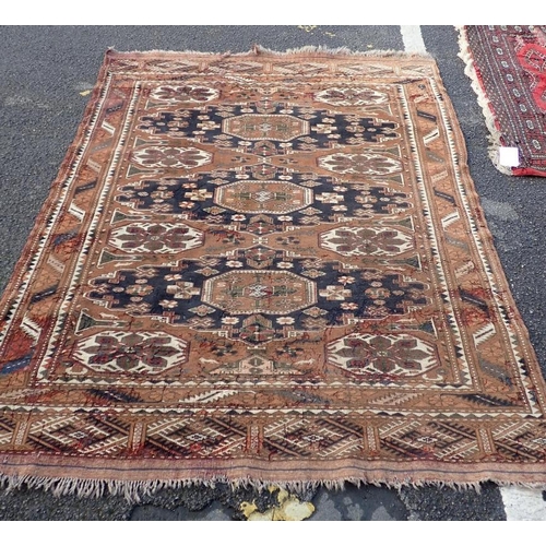 528 - A BELUCH RUG OF KAZAK STYLE

woven in muted colours and off white with three octagonal guls and othe... 