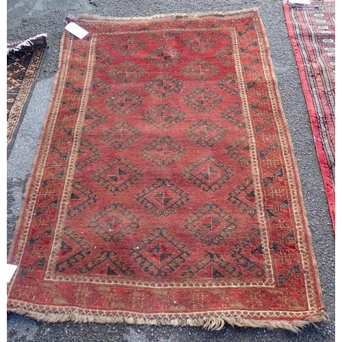 528 - A BELUCH RUG OF KAZAK STYLE

woven in muted colours and off white with three octagonal guls and othe... 