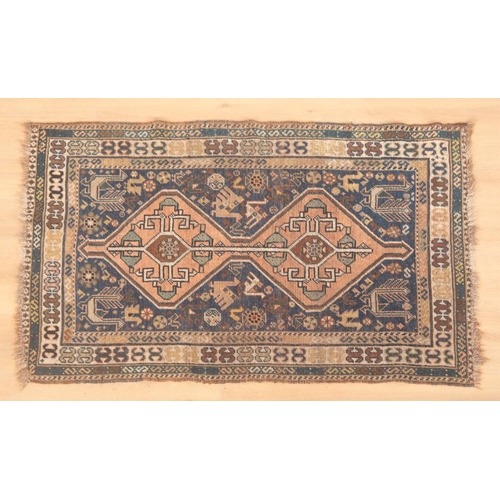 530 - AN ANTIQUE QASHQAI OR KHAMSEH RUG

woven in colours with twin linked lozenge medallions, murgli and ... 