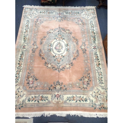 532 - A LARGE CHINESE PINK GROUND RUG

with floral decoration 272 x 388cm approx, including fringes