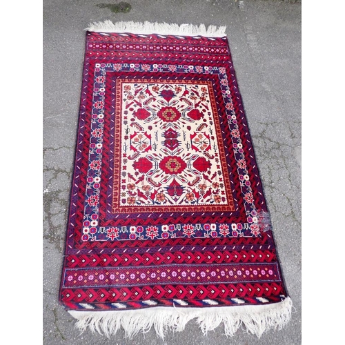 533 - AN AFGHAN 'WAR RUG' WITH MACHINE GUN MOTIFS

on an otherwise traditional design 114 x 205cm approx, ... 