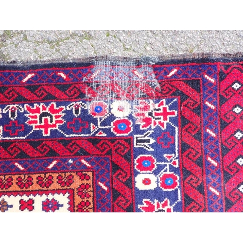 533 - AN AFGHAN 'WAR RUG' WITH MACHINE GUN MOTIFS

on an otherwise traditional design 114 x 205cm approx, ... 