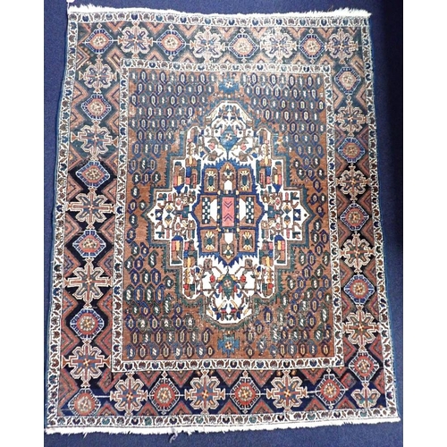 535 - A SHIRVAN RUG

in muted blues and reds 120 x 152cm approx (wear and fading)