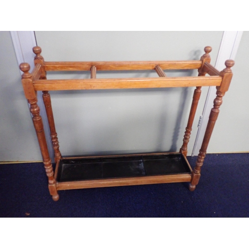 538 - A VICTORIAN WALNUT STICK STAND

three divisions with tin drip tray 75cm wide