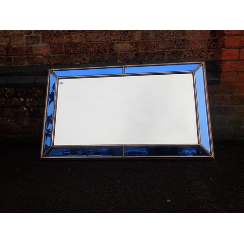 539 - A 1930s ART DECO CUSHION FRAMED WALL MIRROR

with blue margins, within gilt gesso framing 67 x 113cm... 