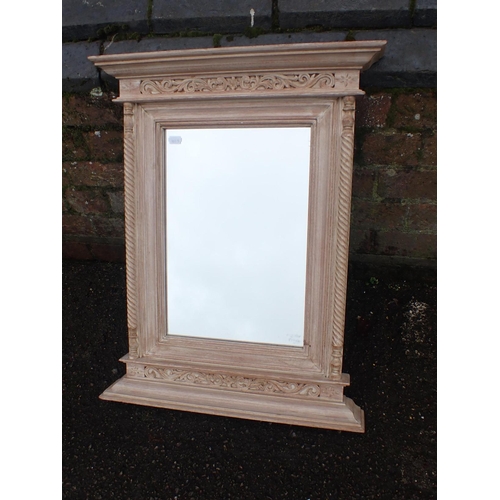 542 - A CARVED AND LIMED HARDWOOD FRAMED MIRROR

with spiral turned half columns 63 x 50cm