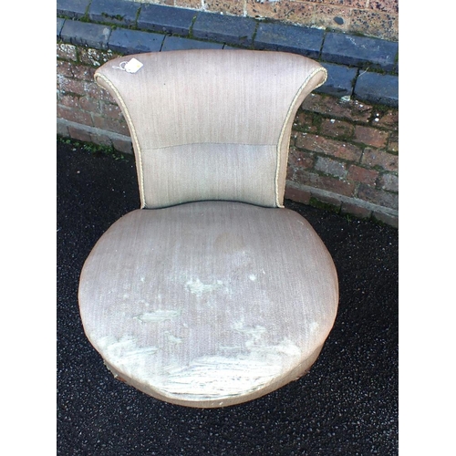 566 - A VICTORIAN LOW UPHOLSTERED CHAIR

with circular seat, on turned legs with Collinson and Cope patent... 