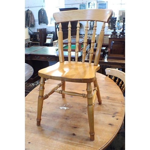 583 - A PINE OVAL KITCHEN TABLE

106 x 152cm, and three beech Windsor type kitchen chairs, one with arms