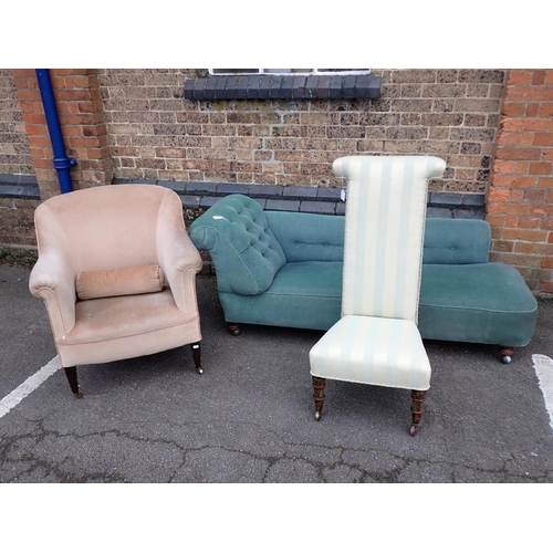 599 - AN EDWARDIAN UPHOLSTERED TUB CHAIR

with tapering front legs and brass castors, a Victorian prie-die... 