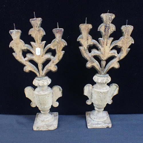 84 - A PAIR OF CONTINENTAL CARVED GILTWOOD CANDELABRA

with three foliate branches on turned urn bases, w... 