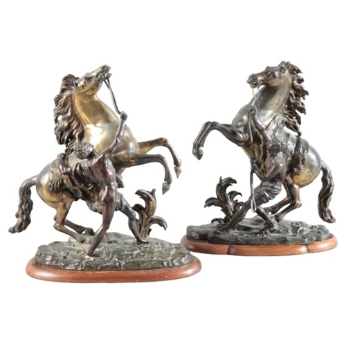 150 - AFTER GUILLAUME I COUSTOU (1677-1746) A pair of brass marly horses

signed to the bases, raised on w... 