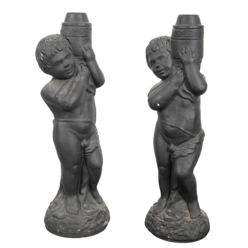 160 - A PAIR OF BLACK PAINTED COMPOSITE CHERUBS

20th century, each figured holding a drilled torchère, on... 