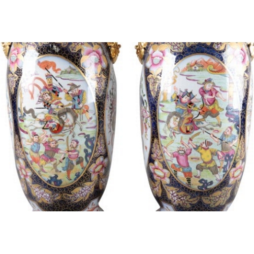 2 - A PAIR OF CONTINENTAL PORCELAIN BALUSTER VASES

19th century, with flared neck and gilt handles, dec... 