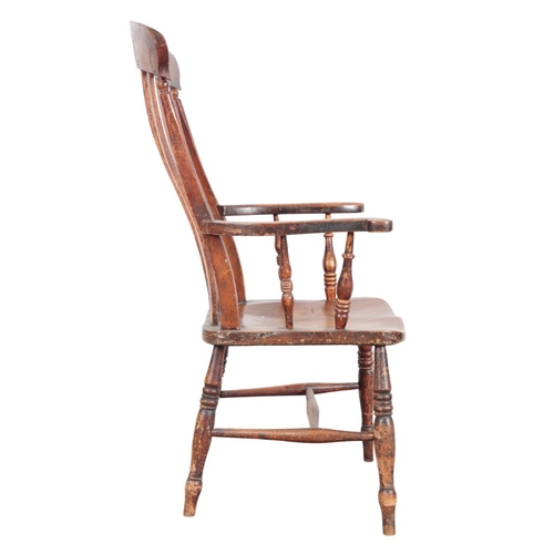 210 - A VICTORIAN LATH BACK WINDSOR ARMCHAIR

with a shaped elm seat on ring turned and tapered legs joine... 