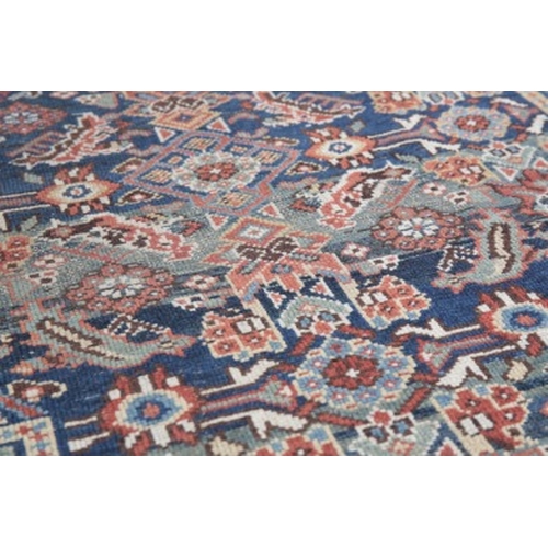 217 - AN ANTIQUE PERSIAN HAMADAN KELLAH CARPET

late 19th century, the central medallion on a madder red g... 