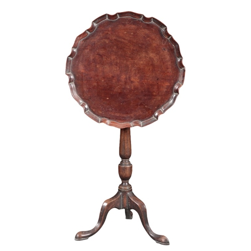 218 - A GEORGE III MAHOGANY TRIPOD TABLE

the tilt top with a pie crust edge, on a baluster turned stem to... 