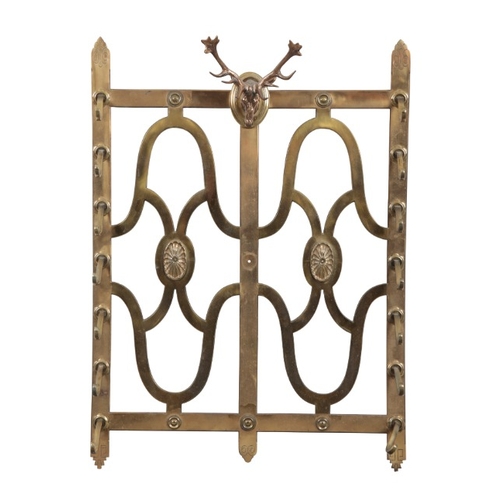 219 - AN EDWARDIAN SCOTTISH HUNTING LODGE BRASS WALL MOUNTED STICK RACK

with seven graduating hooks, surm... 