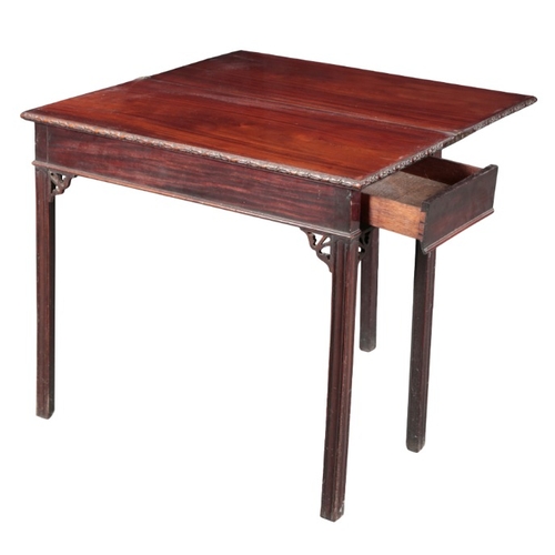 223 - A GEORGE III MAHOGANY TEA TABLE

the hinged rectangular top with foliate carved edges, on moulded bl... 