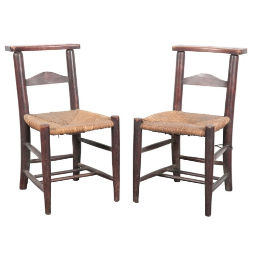 231 - A SET OF THIRTEEN BEECH SIDE CHAIRS

19th century, with shaped back splats over rush seats on tapere... 