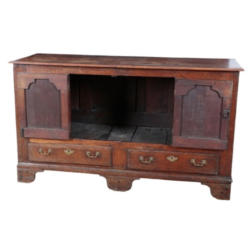 243 - AN ENGLISH OAK SIDEBOARD

18th century and later, with cupboard doors set into the panelled front, t... 